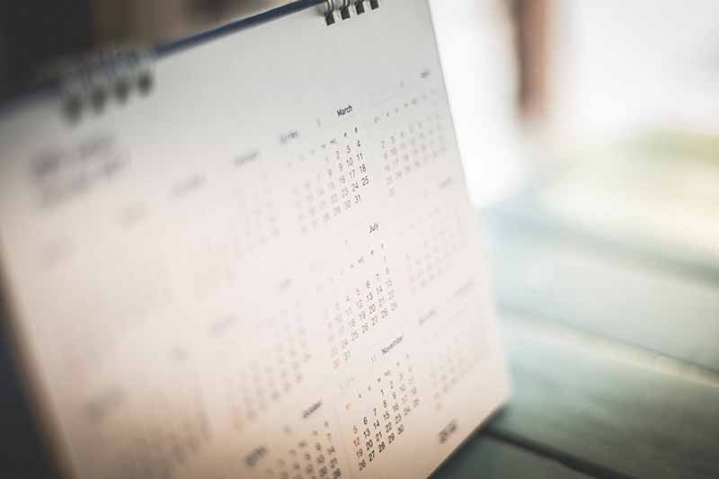 A calendar on a wooden surface in soft focus.